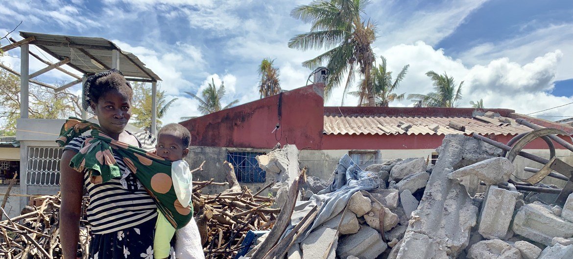A woman and her baby stand in the rubble of Cyclone Idai, that struck central Mozambique in 2019.