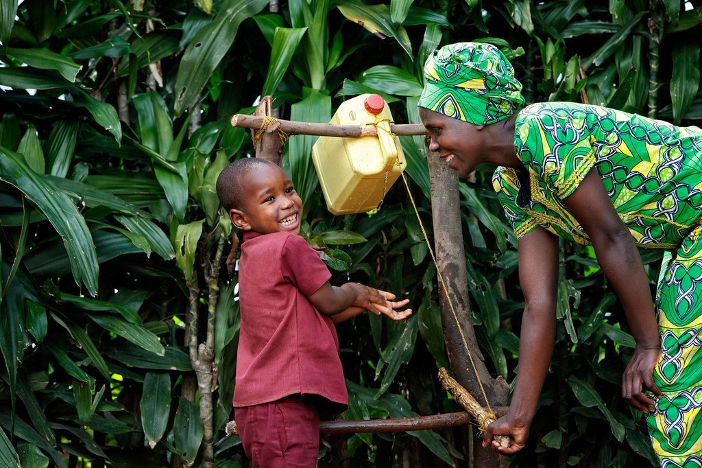 Young boy washes his hands in Gicumbi, Rwanda.