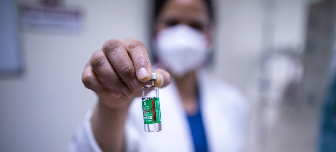 A health worker holds a vial of of COVID-19 vaccine at a hospital in New Delhi, India.