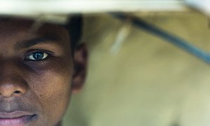 A boy who was forced to work in a factory in Hyderabad, India is pictured outside his home.