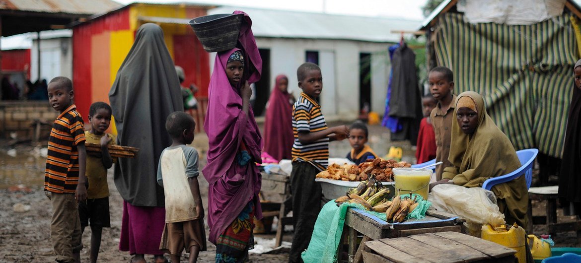 Women and children at a market stand in Kurtunwaarey , Somalia.