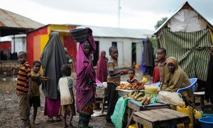 Women and children at a market stand in Kurtunwaarey , Somalia.