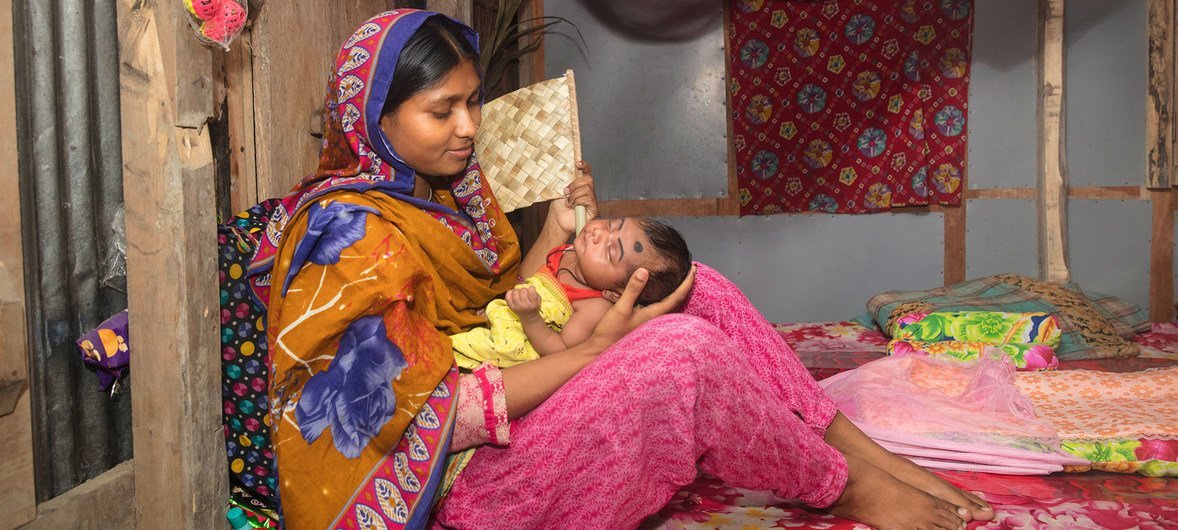 في بنغلاديش، أم تحتضن رضيعها ابن 27 يوما والذي أعيد توا لبيته بعد قضاء ثمانية أيام في المستشفى لتلقي العلاج من الالتهاب الرئوي