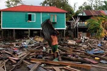 A resident of Puerto Cabezas (Bilwi), the main town on Nicaragua's Northern Caribbean region, clears the debris on his home after the passage of Hurricane Eta.