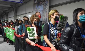 Civil organizations march inside the venue at the COP26 Climate Conference in Glasgow, Scotland, in a demonstration on the last day.