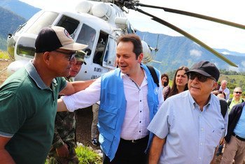 联合国哥伦比亚核查团团长卡洛斯·鲁伊斯·马谢乌(中)在前往哥伦比亚安蒂奥基亚执行实地任务时向一名前战斗人员致意。