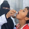 A health worker administers a vaccination against cholera on a young boy in Yemen.