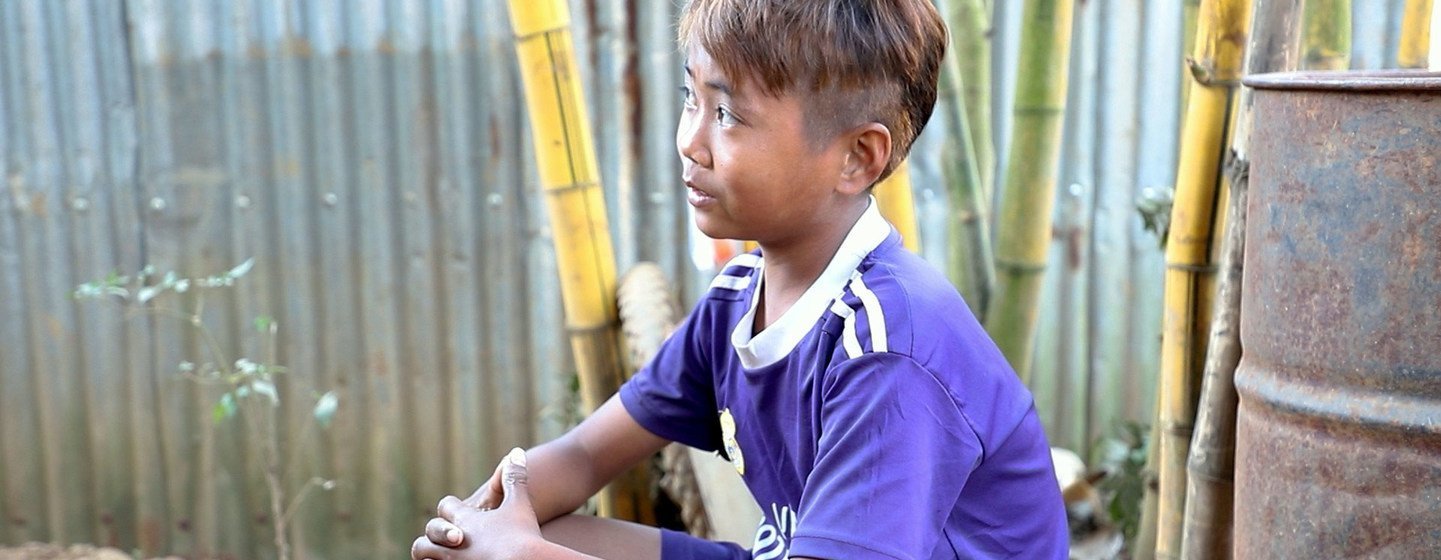 13-year-old San Min Htet scavenges for scraps of jade stone in northern Myanmar.
