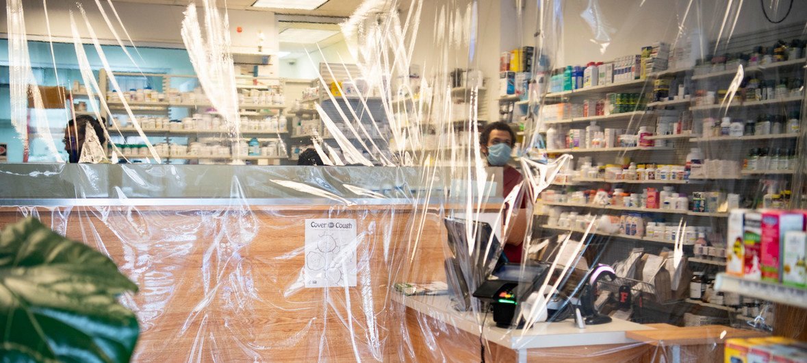 A view of a pharmacy through protective plastic in Astoria, Queens, during the COVID-19 outbreak in New York City.