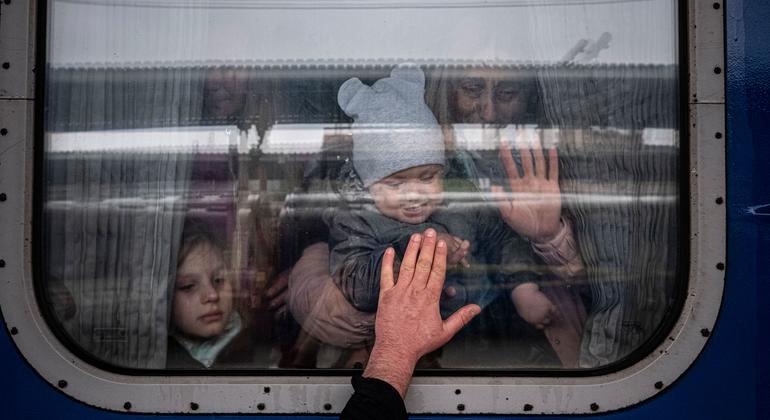 Em Kharkiv, na Ucrânia, homem se despede de sua esposa e filhos antes de partirem em um trem especial de evacuação