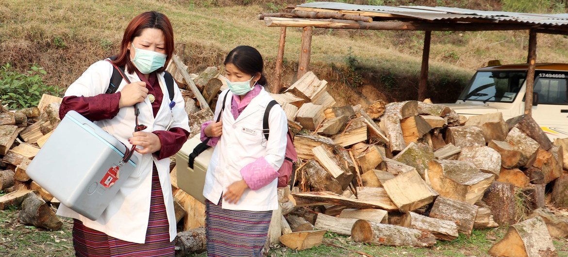 Health assistants set up a vaccination centre at a school in Dagana district.