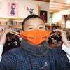 A grade six student in Paro, Bhutan, promotes the wearing of face masks.