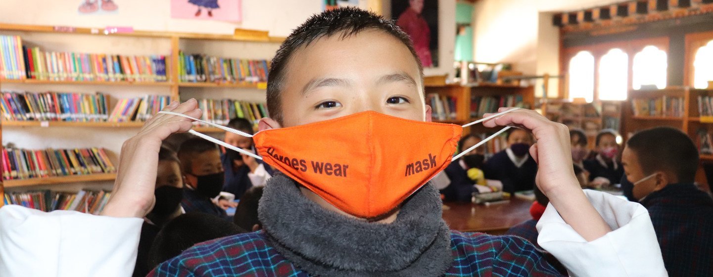 A grade six student in Paro, Bhutan, promotes the wearing of face masks.