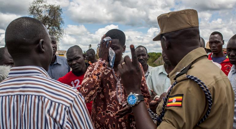 Okello (centre), a community leader in northern Uganda, is trained to de-escalate conflict.