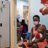 Uma menina de dois anos e sua mãe esperam para ver um médico em Accra, Gana