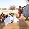 Refugee teacher Hassanie Ahmad Hussein teaches a class outdoors at the school in Kouchaguine-Moura refugee camp in eastern Chad.