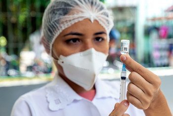A nurse prepares to administer a COVID-19 vaccination northern Brazil.