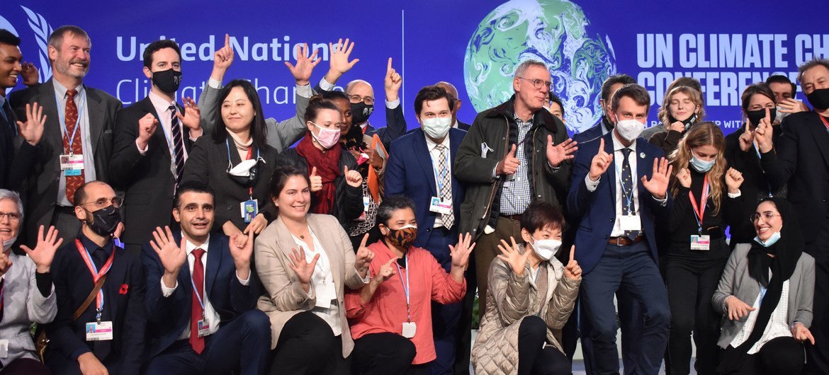 Negotiators marking the closing of the United Nations climate summit, COP26, which opened in Glasgow, Scotland, on 31 October.  The conference sought new global commitments to tackle climate change.