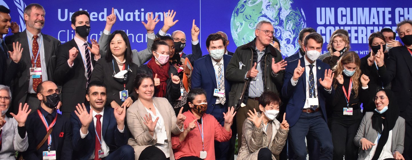 Negotiators marking the closing of the United Nations climate summit, COP26, which opened in Glasgow, Scotland, on 31 October.  The conference sought new global commitments to tackle climate change.