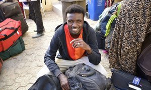 A quick smile from one of the 183 refugees resettled, originating in Sudan and the Central African Republic, prepares for his new life in France.