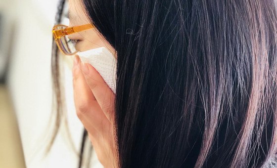 A Woman coughs into a tissue. (file)