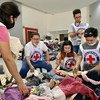 Students volunteer at a Red Cross logistics centre to pack relief goods for victims of the Taal volcano in the Philippines.