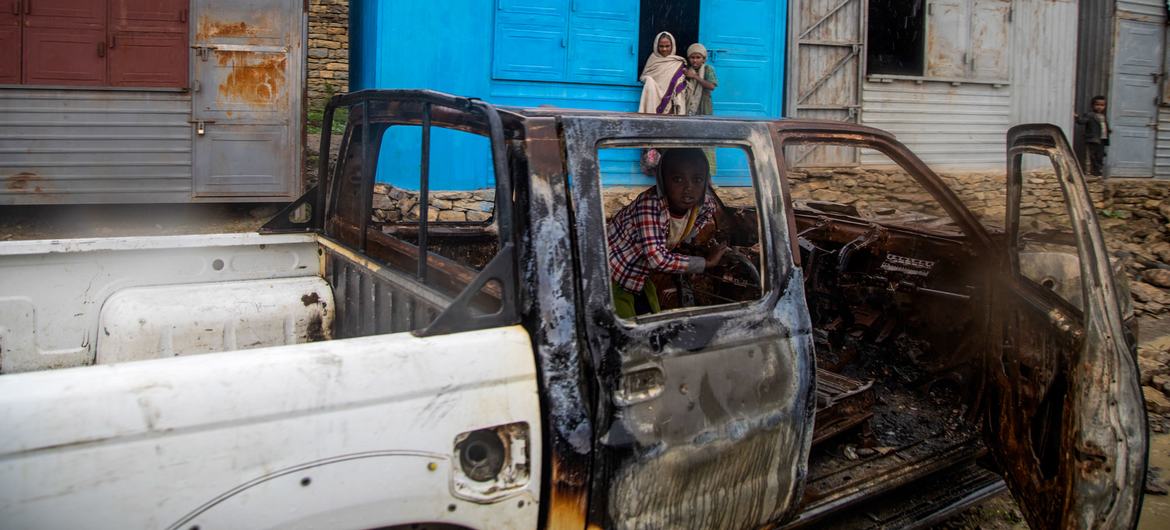 A child sits inside a vehicle burned out during fighting in the Tigray region of northern Ethiopia.