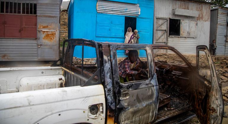 A child sits inside a vehicle burned out during fighting in the Tigray region of northern Ethiopia.