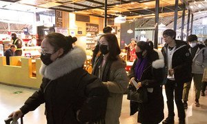 People wear face masks at Chengdu Shuangliu International Airport in China.