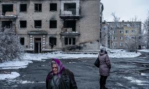 People walk past a residential building destroyed by shelling in Donetsk Oblast, Ukraine. (file)