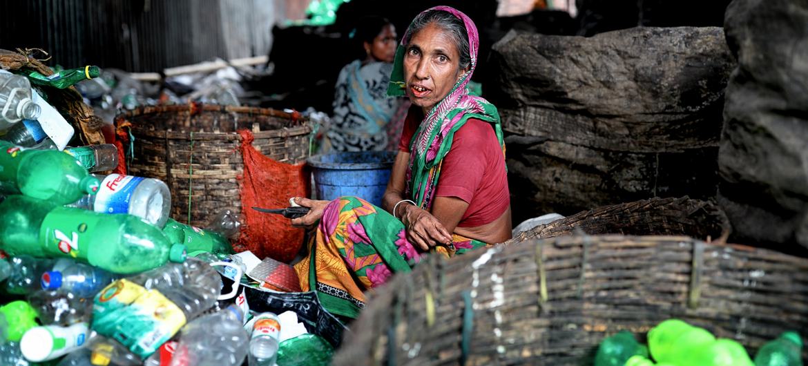 A woman works in a plastic recycling factory in Bangladesh.