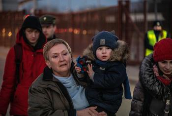 A family reaches Berdyszcz in Poland, after crossing the border from Ukraine, fleeing escalating conflict.