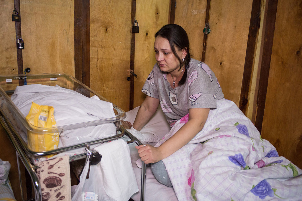 Una madre que acaba de tener a su bebé en una sala de maternidad improvisada en un hospital de Kyiv, Ucrania.