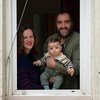 León, de 7 meses, y sus padres ven desde su casa el espectáculo de marionetas que hacen sus vecinos en Madrid, España