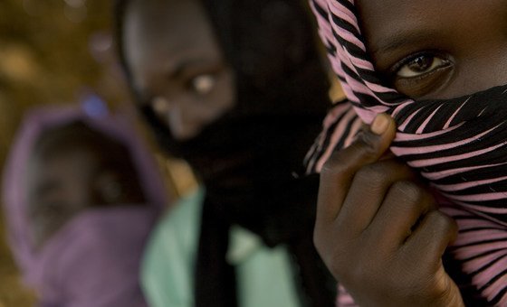 A 12-year-old girl (right) who lives in a camp for displaced people in North Darfur State, Sudan, says she was raped by government soldiers.