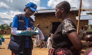 Marie-Roseline Darnycka Bélizaire, an epidemiologist with the World Health Organisation, speaks to a woman as part of the contact tracing effort during an Ebola outbreak in eastern Democratic Republic of the Congo.