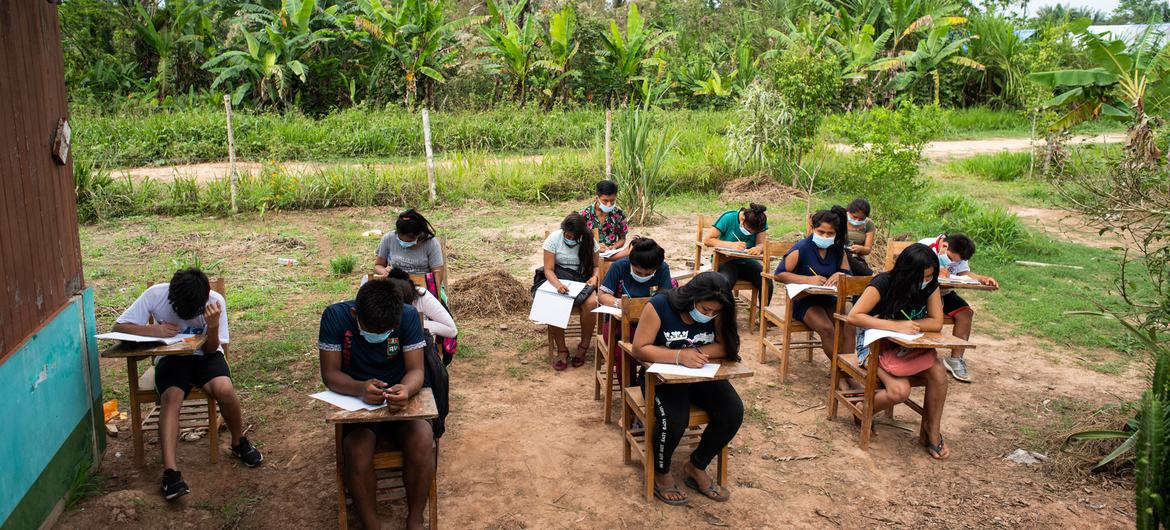 Students sit outside of E Alfonso Ugarte school in San Rafael Shipibo community in the Masisea district of Peru due to classes being suspended during the COVID-19 pandemic.