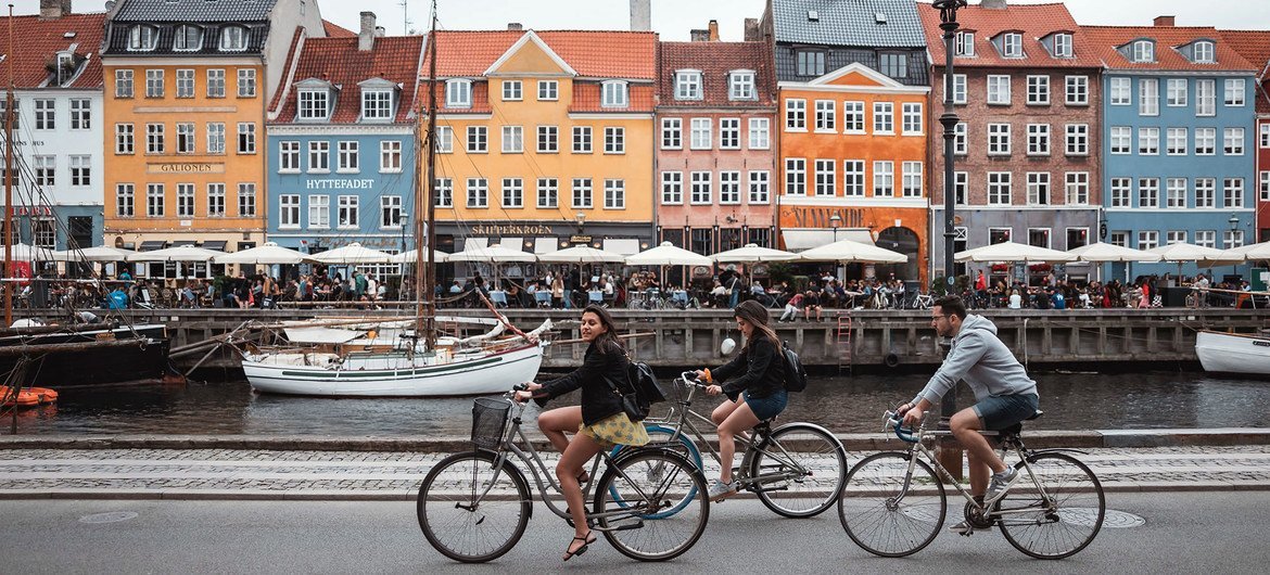 Tourists biking at Nyhavn in Copenhagen, Denmark.