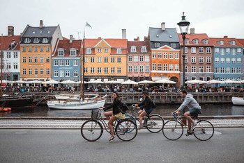 Unos turistas pedalean por los alrededores de Nyhavn, en Copenhague (Dinamarca).