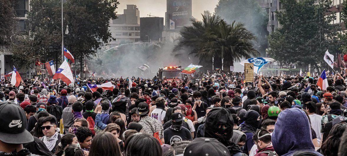 Des personnes manifestent dans les rues de Santiago, la capitale du Chili.