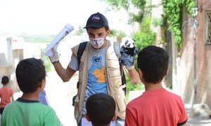 A young volunteer uses a hand puppet to educate children on COVID-19 awareness in northern rural Homs, Syria.