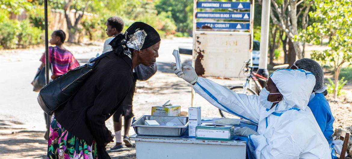 ज़िम्बाब्वे में एक महिला, एक अस्पताल में अपनी तापमान जाँच कराते हुए.