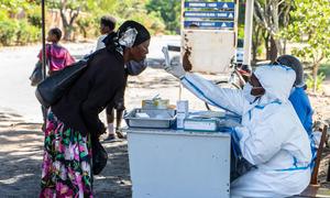A woman gets her temperature checked before entering a hospital in Bulawayo, Zimbabwe.