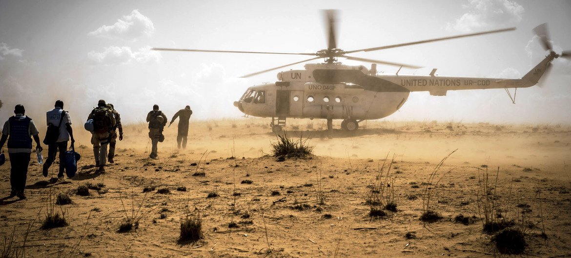 UN peacekeepers return to their helicopter following a mission to the village of Sobane Da in the Mopti region of Mali.