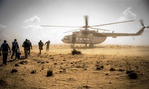 UN peacekeepers return to their helicopter following a mission in the Mopti region of Mali.