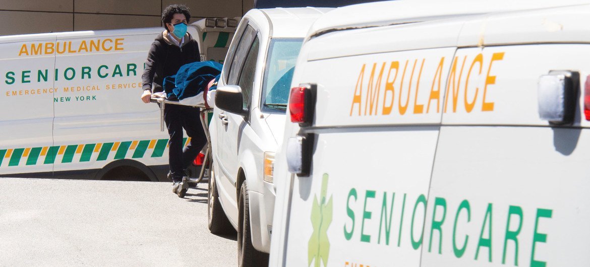 Healthcare workers at a hospital in New York move a patient who died from COVID-19 towards the beginning of the pandemic in the US, in April 2020.