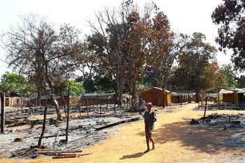 After armed clashes, a child walks among the charred ruins of Alindao, a city in the Central African Republic.