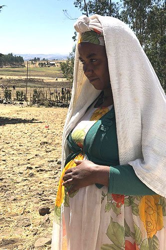 السيدة هيوت (اسم مستعار) تقف في موقع جوندار للنازحين بإثيوبيا.