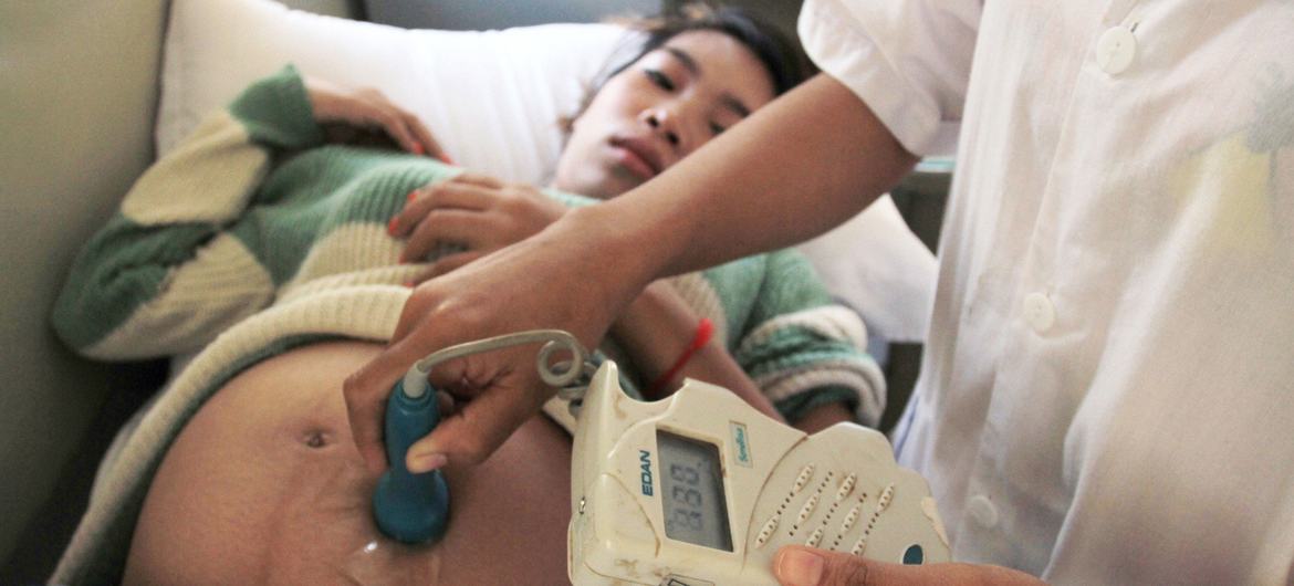 A pregnant woman has prenatal care performed at a hospital in Preah Vihear, Cambodia.