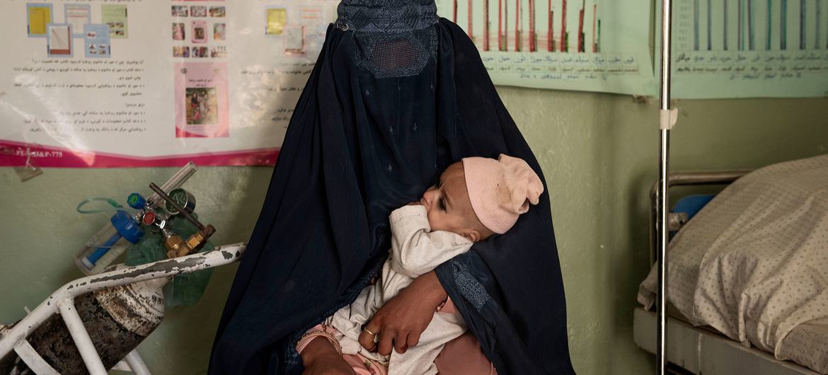 امرأة تحضر ابن شقيقتها المصاب بسوء التغذية الحاد للعلاج في عيادة في قندهار، أفغانستان.